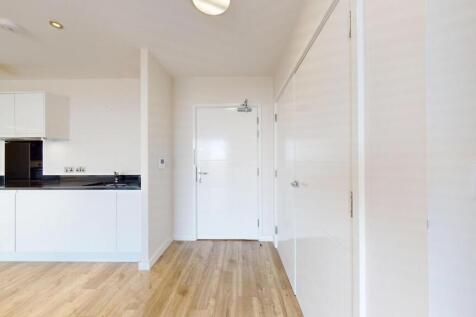 Bright modern hallway with sleek wooden floorin...