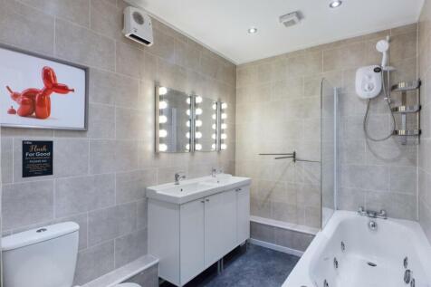 A spacious and modern bathroom featuring a luxu...