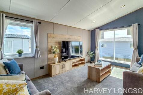Bright lounge with TV and large windows in the ABI
