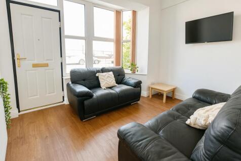 Bright and tidy living room featuring modern bl...
