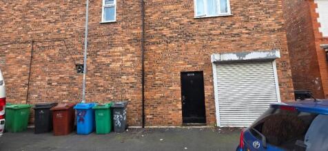 Brick building rear with parking and bins...
