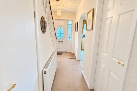 Welcoming Hallway with Stained Glass Door.png
