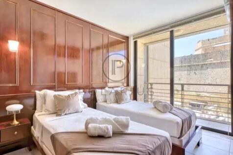 Modern bedroom with two comfortable beds, wooden w