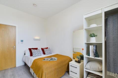 A bright and inviting double bedroom featuring ...
