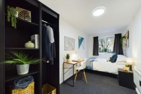 A spacious and well-lit double bedroom featurin...