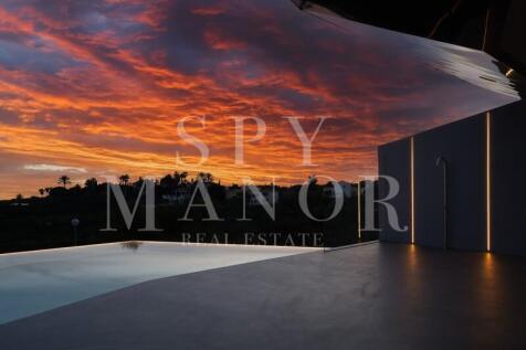Private infinity pool with panoramic ocean views under sunset sky in Carvoeiro Algarve