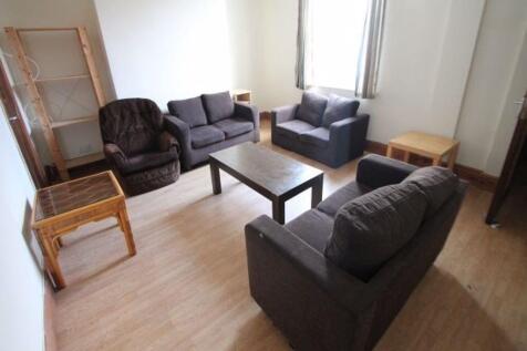 A cozy and well-kept living room featuring mult...