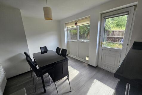 Bright and spacious living area with large wind...