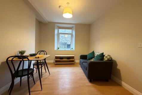 Neat, simply furnished living room with a compa...