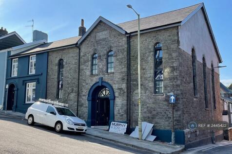 Blue Building Adjacement To Methodist Church