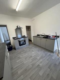 A modern kitchen featuring sleek grey cabinets ...