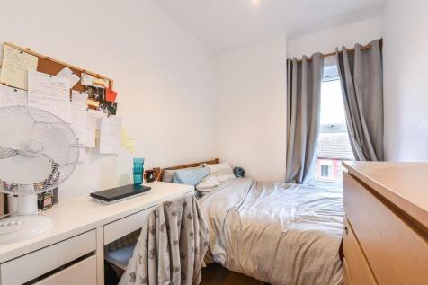 Bright bedroom with a large desk and natural li...