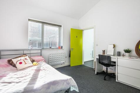 Bright, modern bedroom with a double bed by a l...