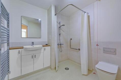 a bathroom with a shower and sink