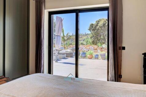 patio doors lead to the pool and gardens