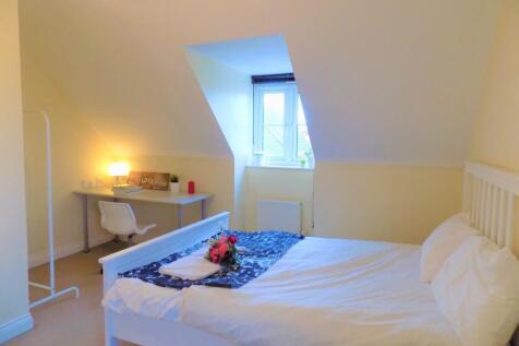 Bright and cozy double bedroom featuring a comf...