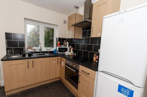 Bright kitchen with modern tiling and appliance...
