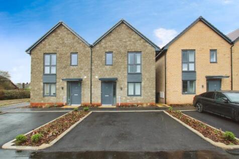 Modern semi-detached houses with neat stone and...