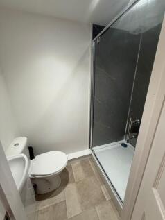Fresh, modern bathroom with a walk-in shower fe...