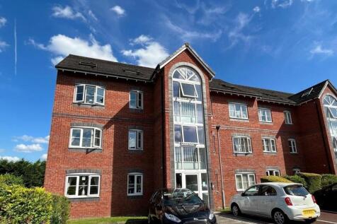 Red-brick apartment building with attractive ar...