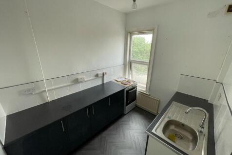 Bright kitchen featuring clean countertops, a m...