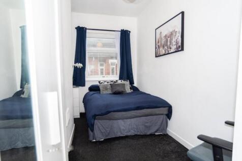 This cozy double bedroom features a comfortable...