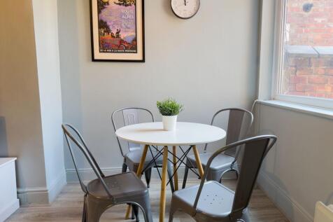 Bright dining area with stylish industrial chai...