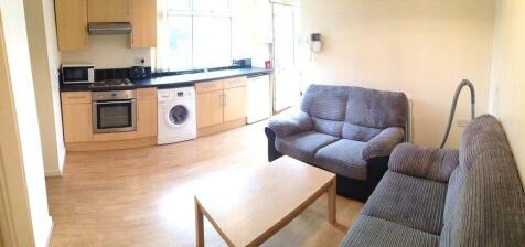 Bright open-plan living area with comfy sofas...