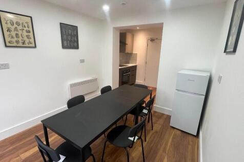 Simple modern kitchen-diner with a long black d...