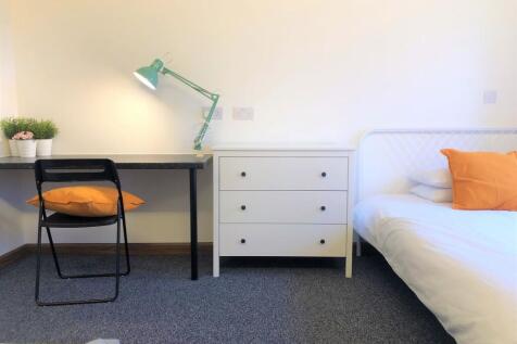 Bright and tidy bedroom featuring a clean white...