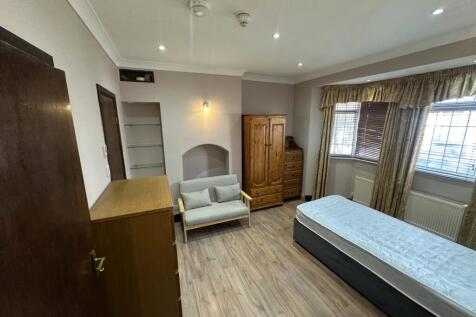 Spacious bedroom with ample storage and seating...