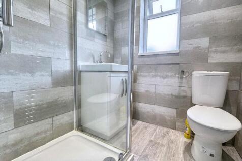 Modern tiled bathroom with sleek walk-in shower...