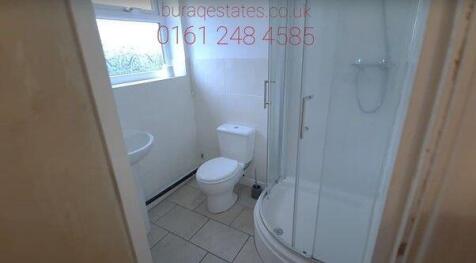 Bright bathroom with modern corner shower suite...