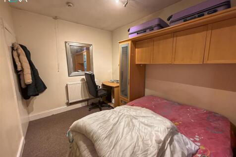 Comfortable bedroom with desk and ample storage...