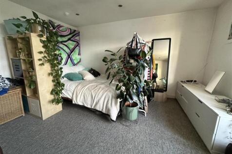 Spacious bedroom with ample storage and greener...
