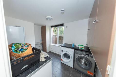 A functional kitchen area featuring laundry app...