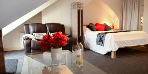 Spacious attic bedroom with cosy seating area...