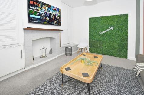 Bright, modern living room with a mounted flat-...