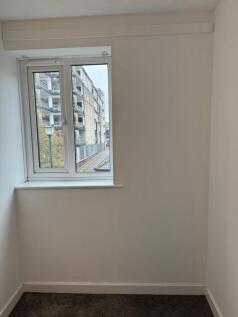 Bright, freshly painted small room with a stree...