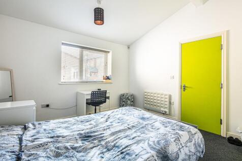 Bright, simply furnished bedroom with a pattern...