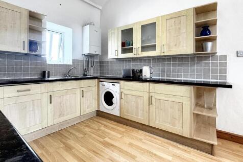 Modern kitchen with ample storage and appliance...