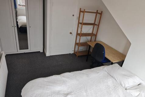 A clean and tidy bedroom space featuring a simp...