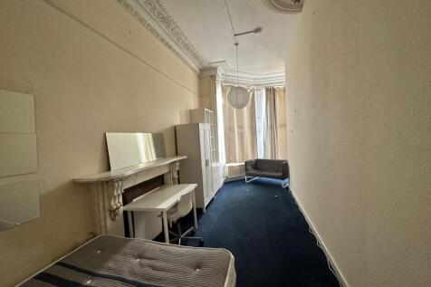 Long single bedroom with high ornate ceilings, ...