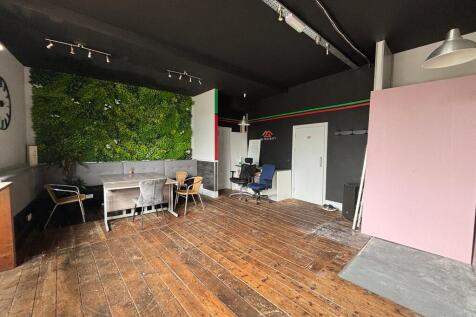 Spacious modern workspace with vibrant green wa...
