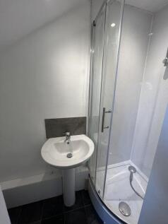 Compact and clean bathroom featuring a modern c...