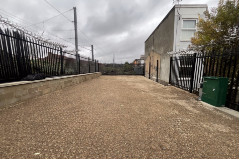 A large plot of land, with metal fencing around it.