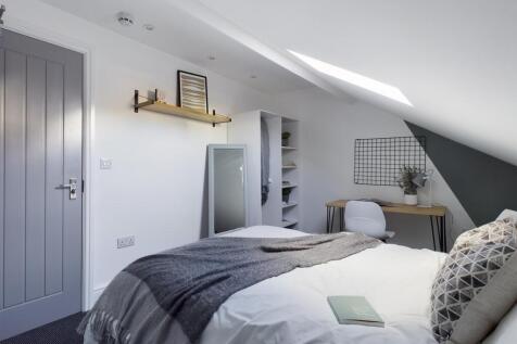 Bright, stylishly decorated double bedroom with...