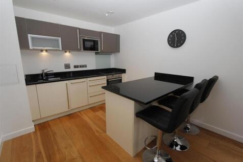 Modern kitchen with stylish breakfast bar islan...