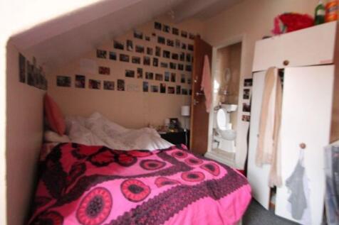 A cozy master bedroom with a comfortable double...