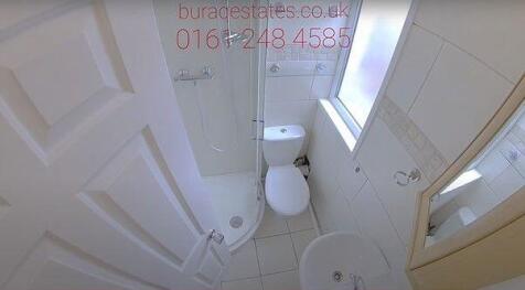 Bright, clean bathroom with tiled floor, a mode...